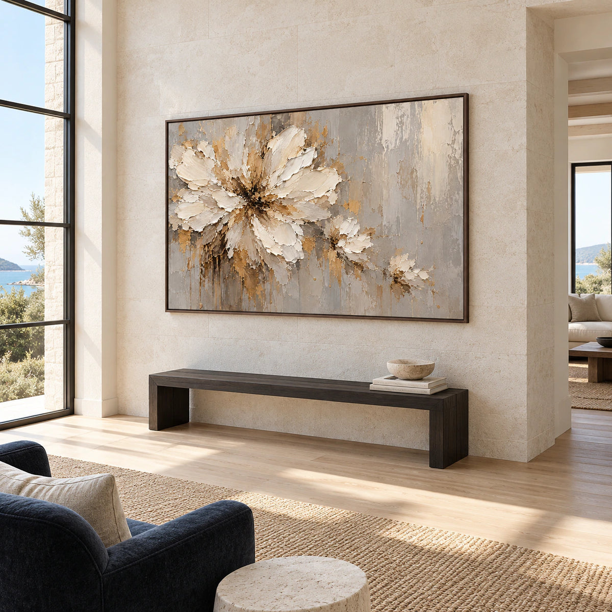 Large floral painting commanding a bright gallery-scale foyer with limestone walls and a sculptural bench.