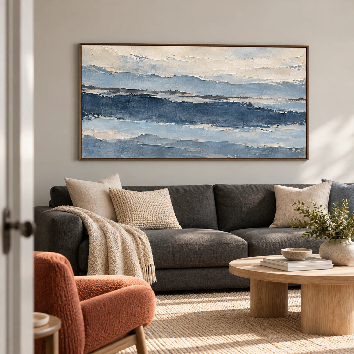 Glacier Ledger displayed above a low charcoal sofa in a bright living room.