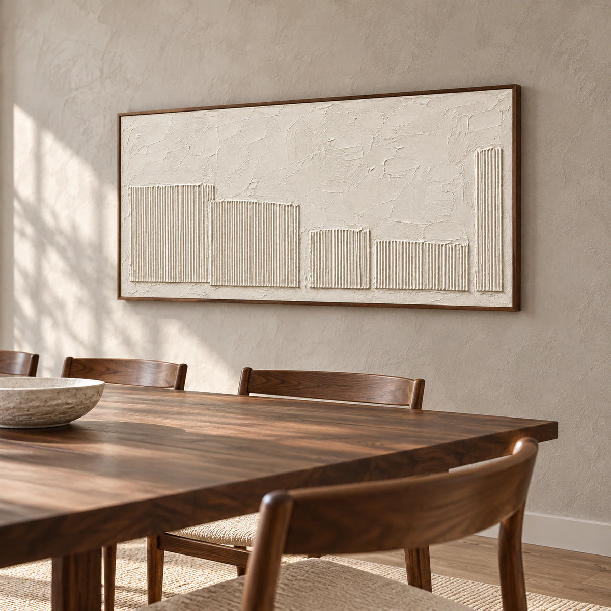 Ivory textured painting on a warm gray dining room wall, viewed from a slight left angle above a long dark wood table with slender chairs.