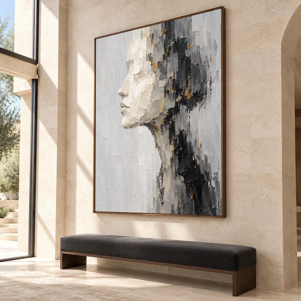 Large vertical ivory profile painting in a bright, high-ceilinged foyer with pale stone architecture, a slim bench and open floor space, viewed from a low left angle.