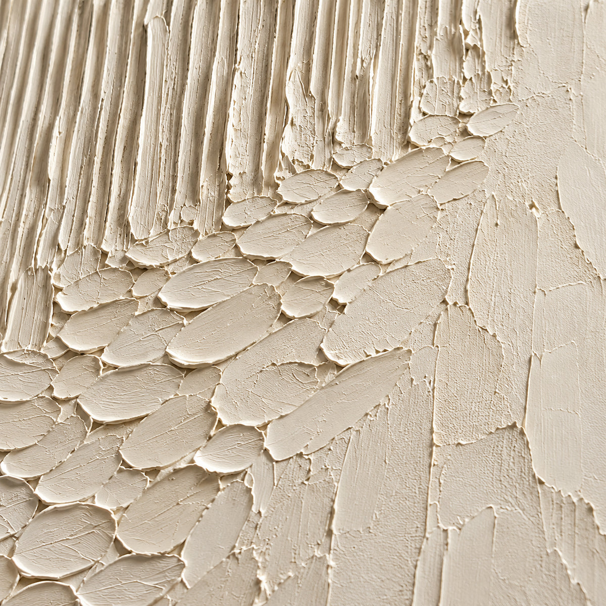 Close detail of Ivory-Cascade from an oblique side angle, with grazing light revealing raised oval marks, vertical grooves and shallow shadows.