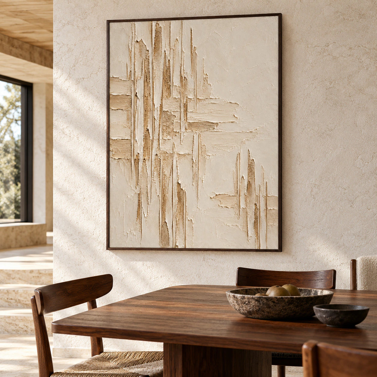 Vertical ivory textured painting on a cool pale stone wall above a dark walnut dining table, viewed from the right in natural daylight.