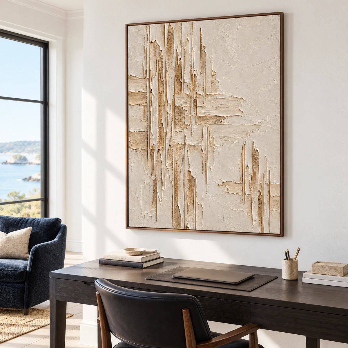 Large vertical ivory ridged painting above a simple dark desk in an airy office and reading space, viewed from the right at standing height.