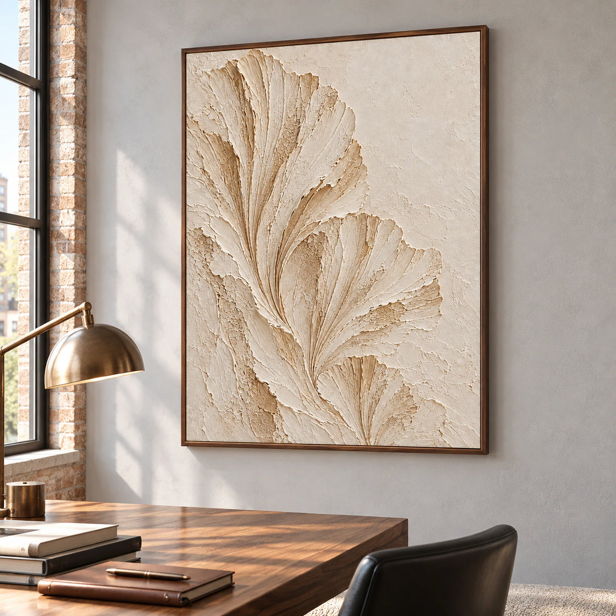 Ivory fan artwork beside a writing desk in an airy home office with daylight and minimal furnishings.