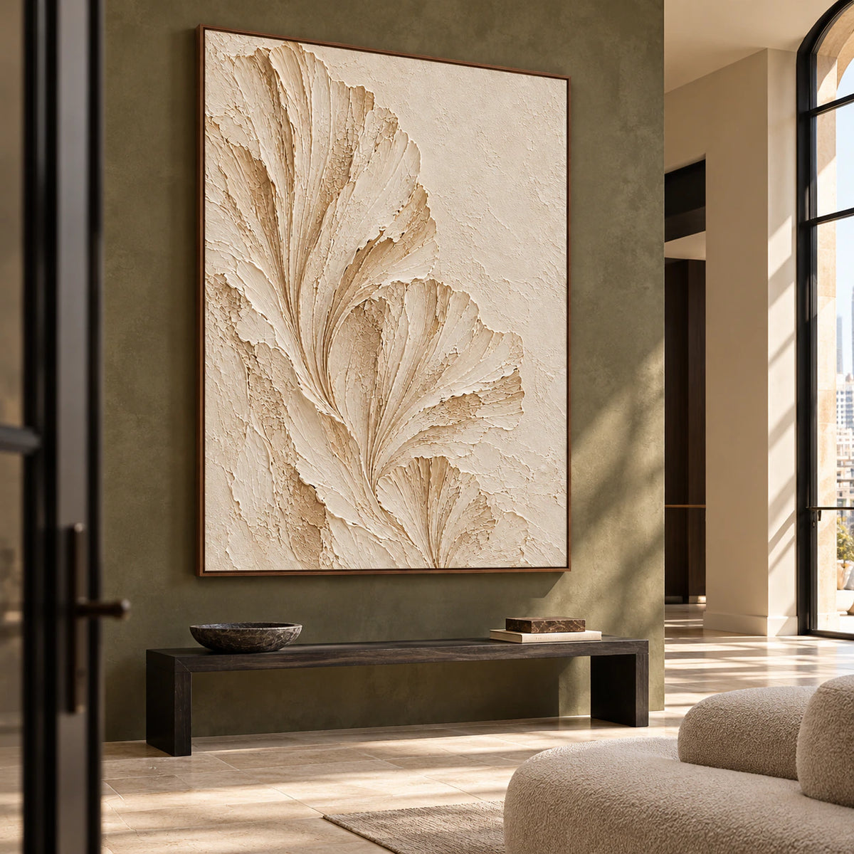 Large ivory fan artwork anchoring a spacious foyer with stone flooring and a restrained console.