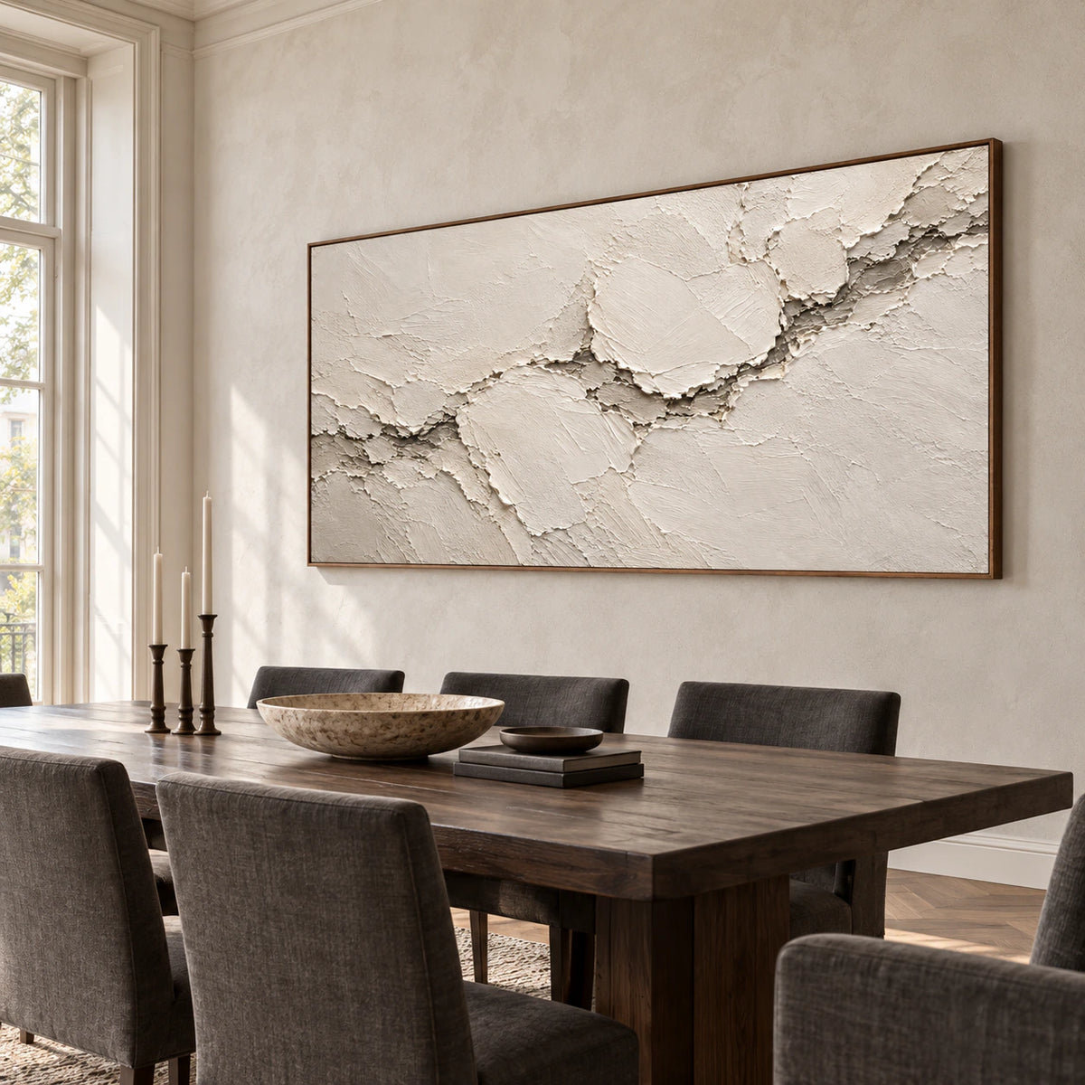 Wide ivory textured artwork anchoring a refined dining room with a long table and natural daylight.
