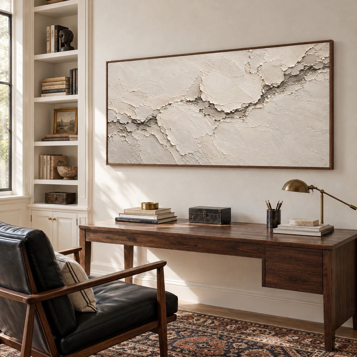 Textured ivory abstract artwork displayed prominently in an airy home office and reading space.
