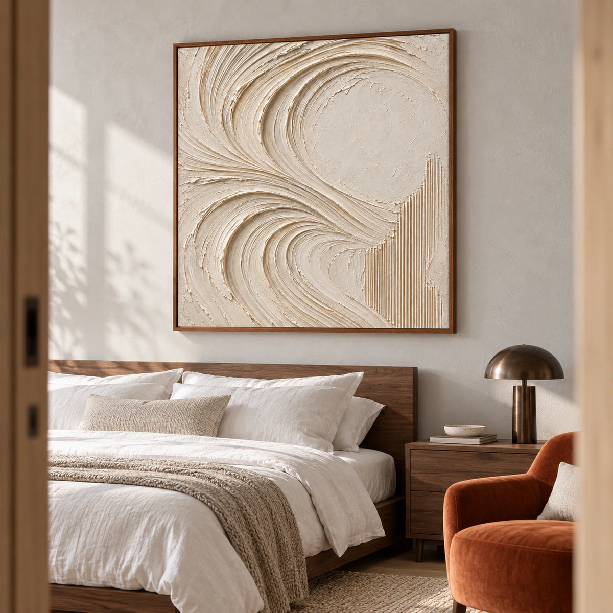 Large square ivory abstract painting above a low walnut bed, viewed from a low left angle, with a pale gray wall, white linen and dark bronze bedside lamp.