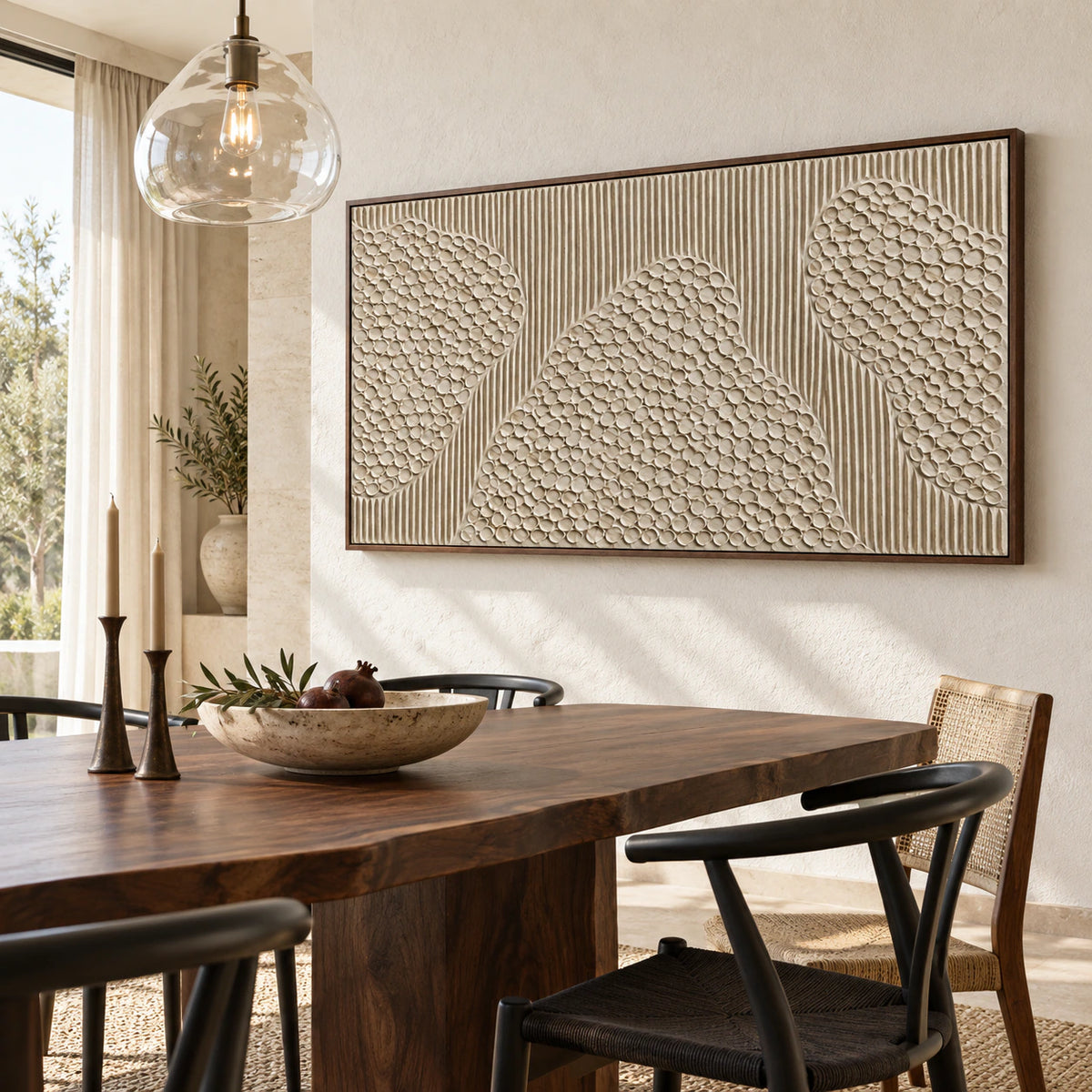 Large ivory relief artwork in a refined daylight dining room with sculptural furnishings.