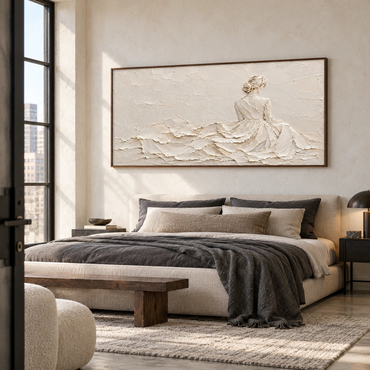 Ivory-Reverie above a simple bed with muted, contrasting bedding in a softly daylit bedroom, viewed from a slight left angle at low height.