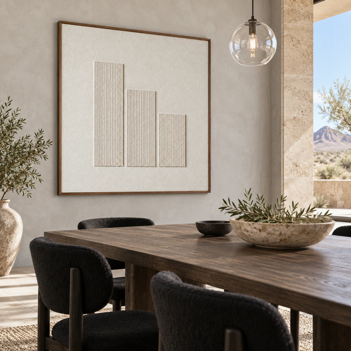 Ivory relief artwork above a refined dining setting in a sunlit architectural interior.