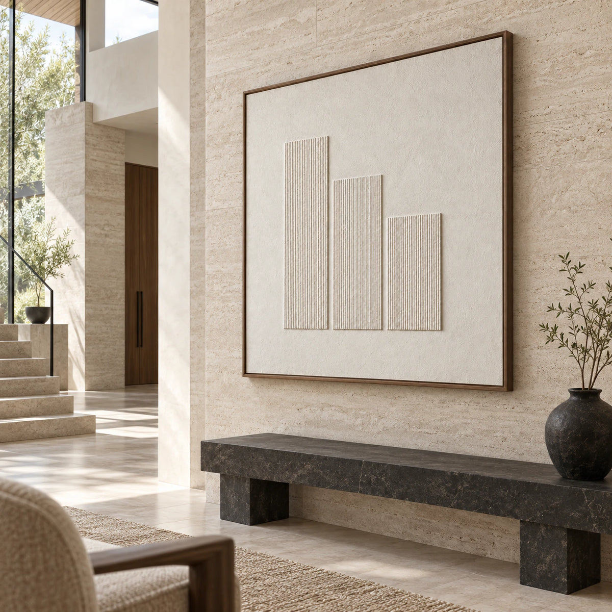Large ivory relief artwork in a gallery-scale daylight foyer.