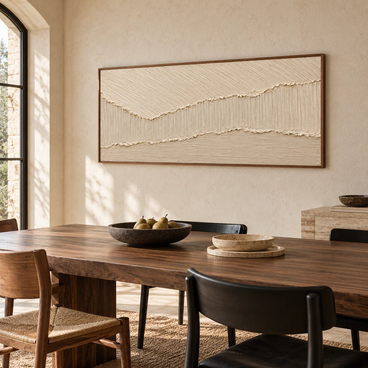Large ivory textured abstract painting anchoring a refined dining room with a dark wood table and simple black chairs.