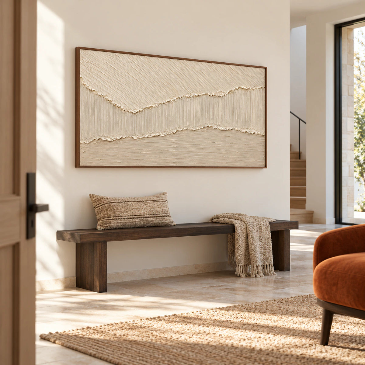 Ivory textured abstract painting commanding the wall of a gallery-scale foyer with stone flooring and a sculptural bench.
