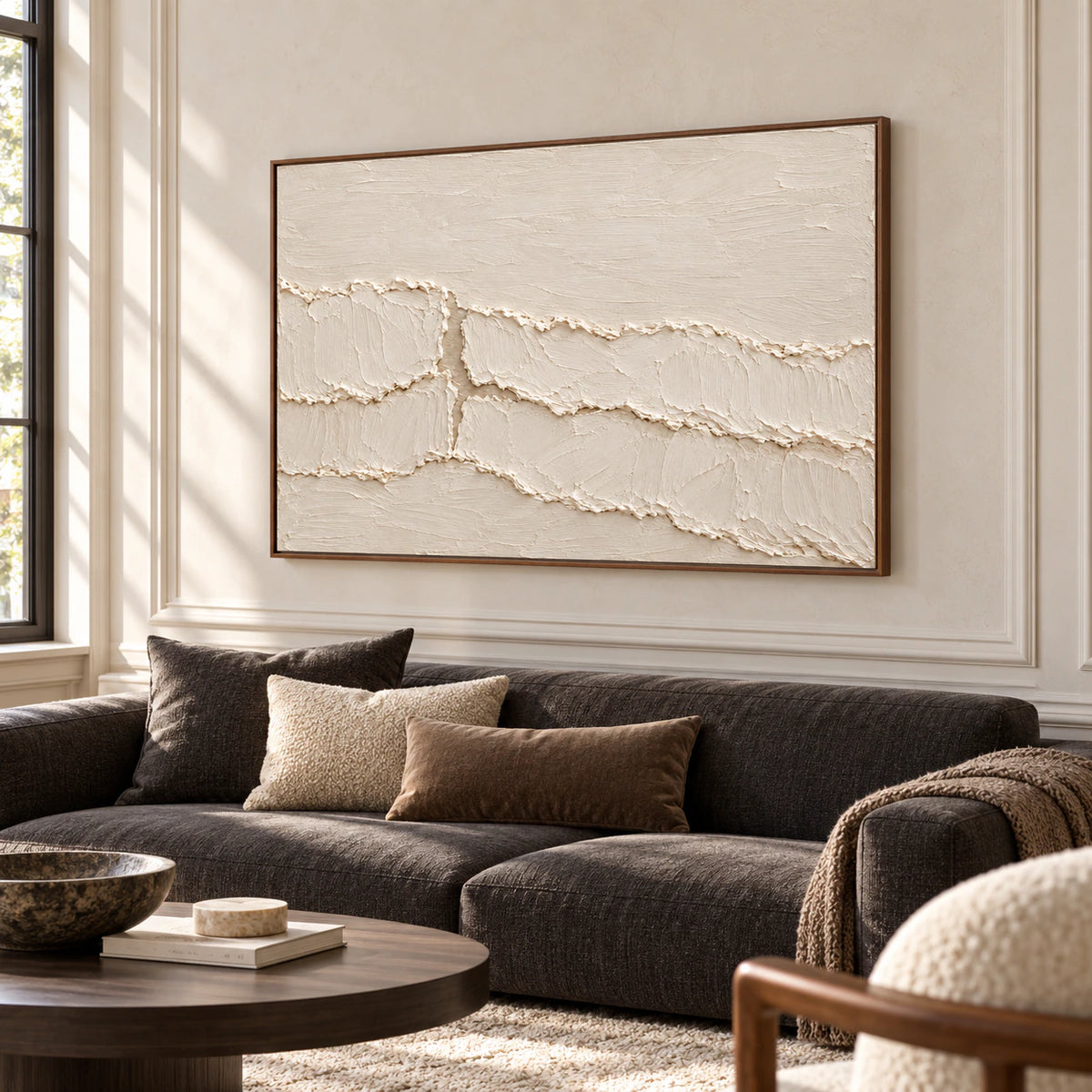 Large ivory textured abstract painting above a charcoal sofa in a bright, open living room.