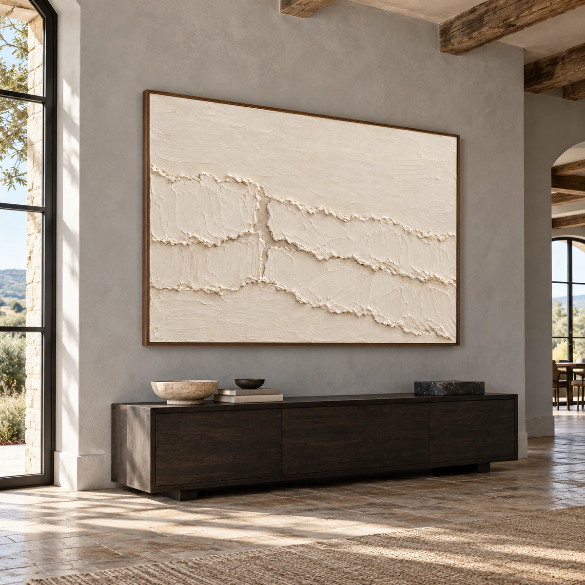 Large ivory abstract painting commanding the wall of a bright gallery-scale foyer with a stone floor.