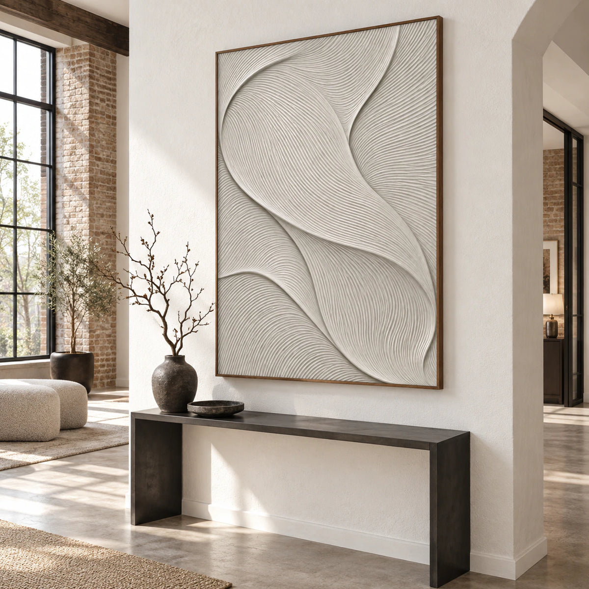 Large ivory ridged abstract artwork anchoring a gallery-scale stone foyer.