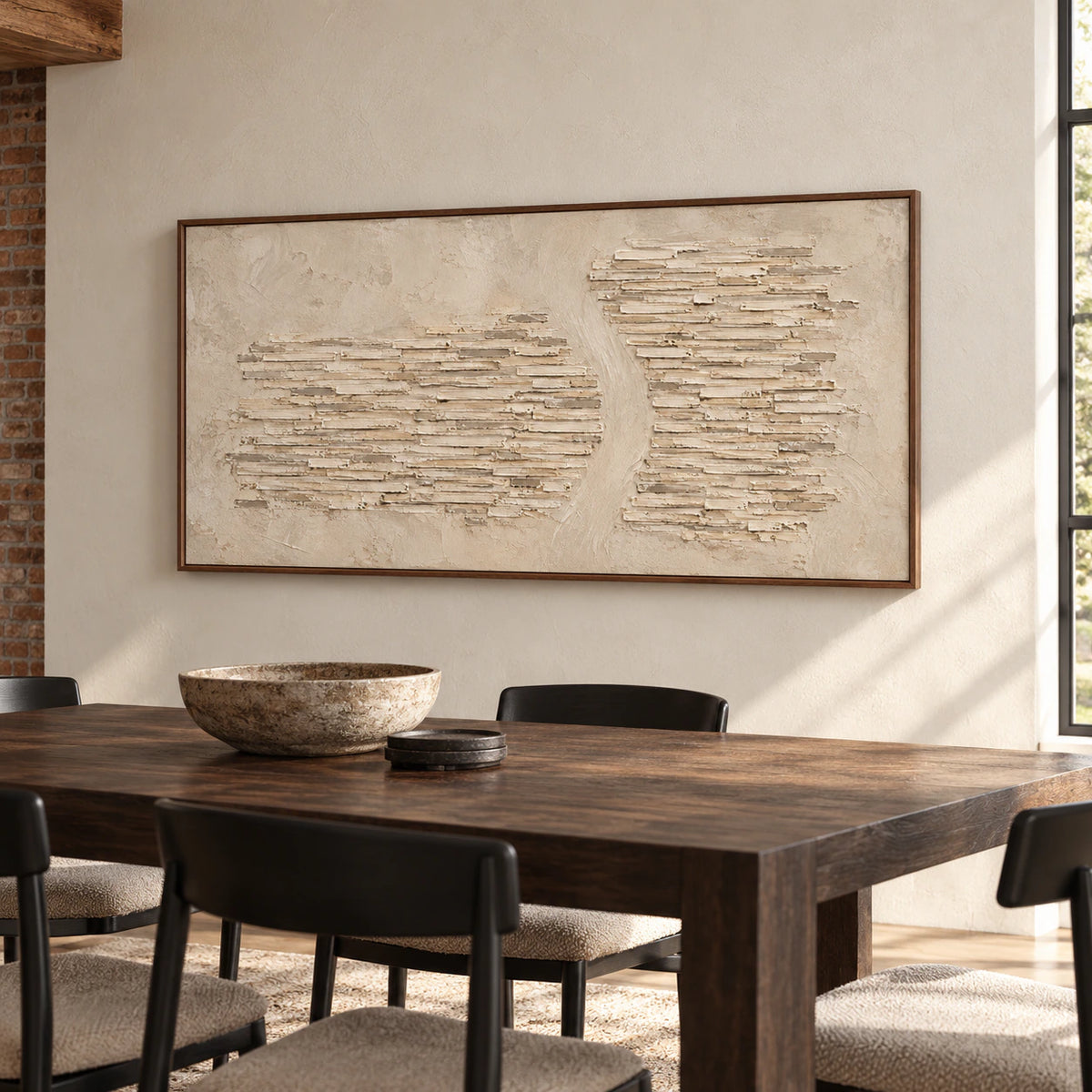 Limestone-Cadence on a warm white plaster wall above a dark wood dining table with black chairs, viewed from the right in daylight.