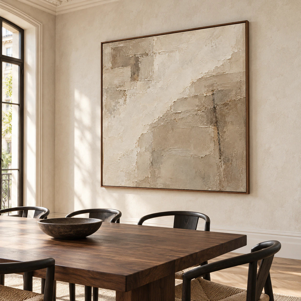 Large square textured abstract artwork anchoring a refined dining room with a dark wood table, sculptural chairs and bright natural light.