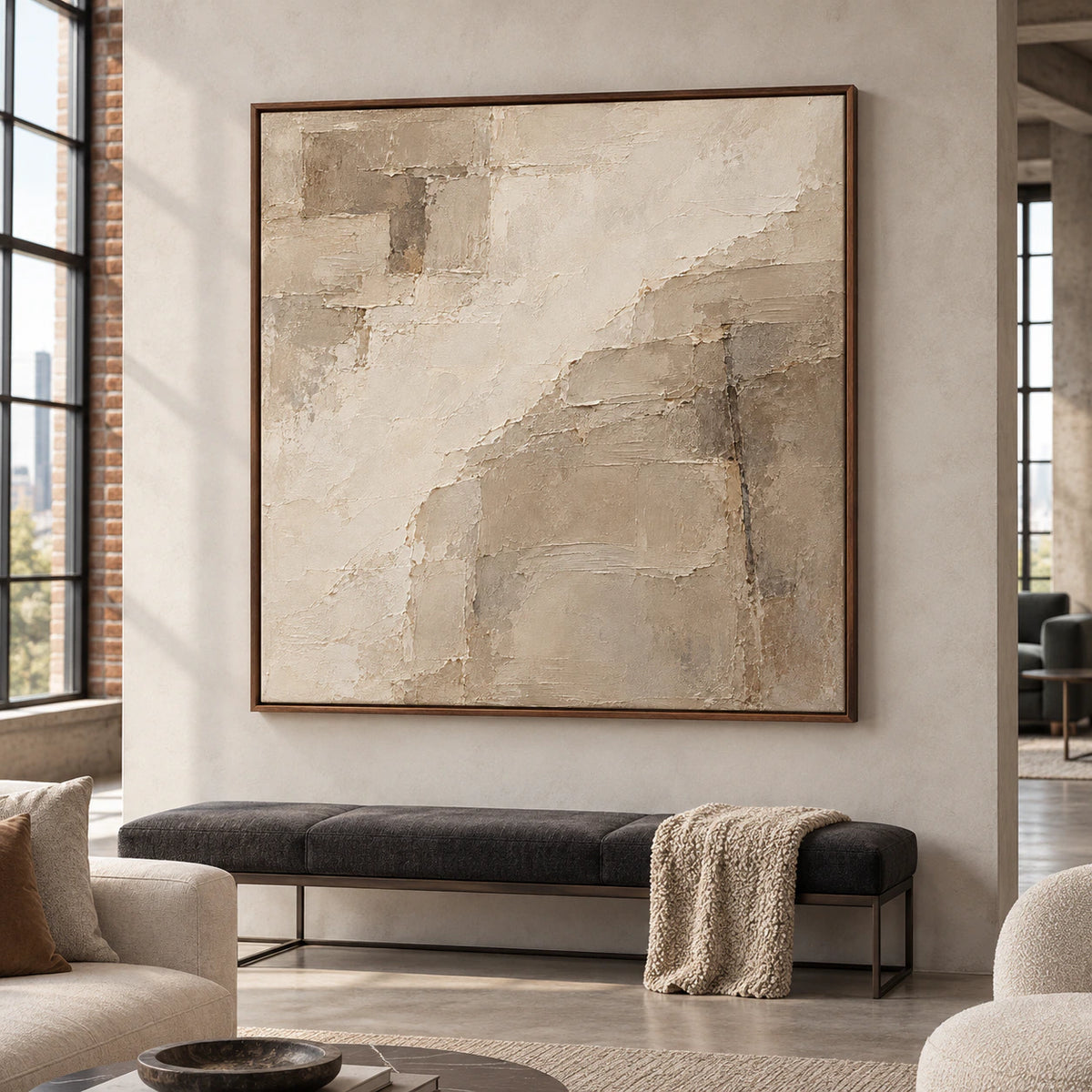 Large square ivory and taupe painting in an expansive loft interior with tall windows, open space and understated furnishings.