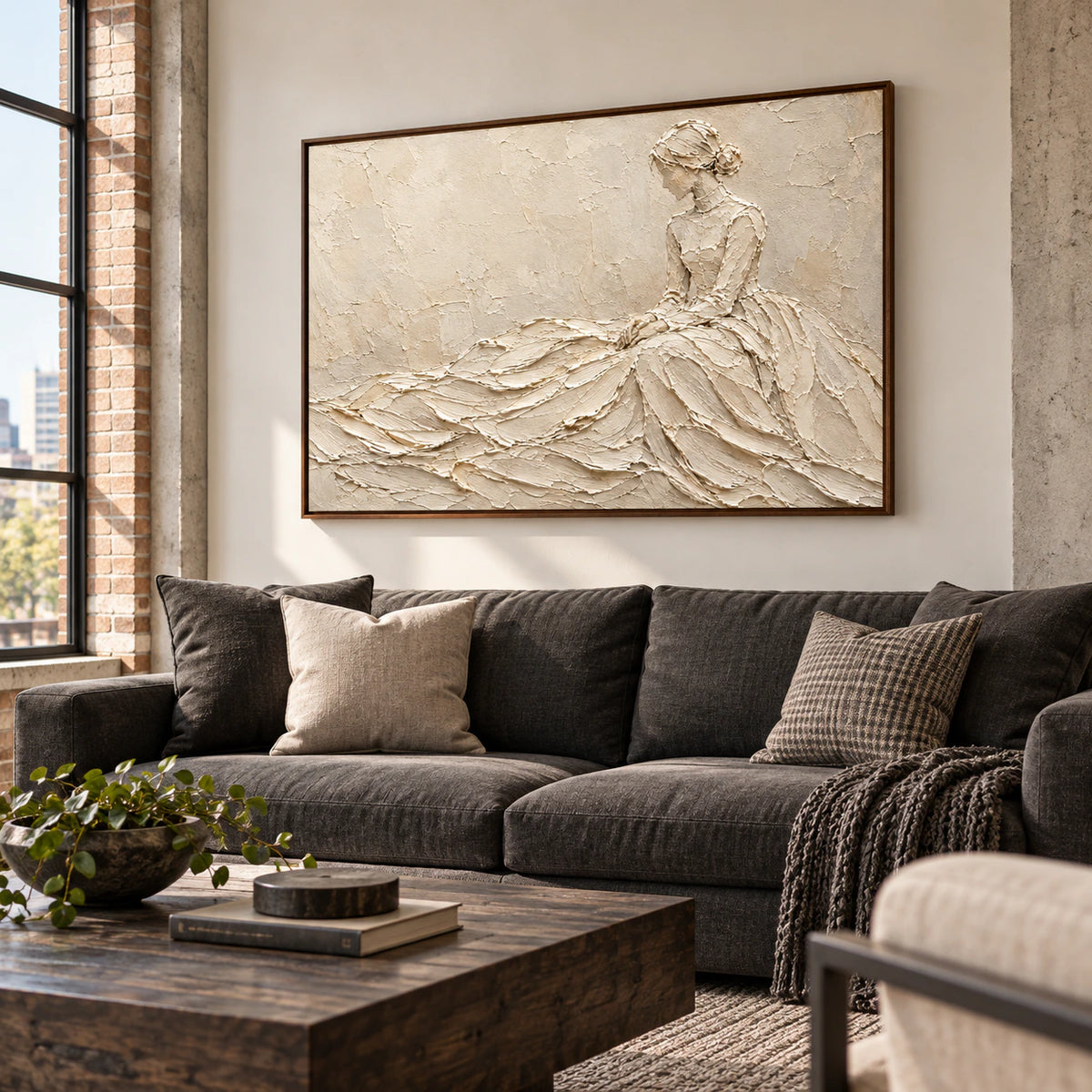 Large ivory figure painting above a charcoal linen sofa in a bright living room.