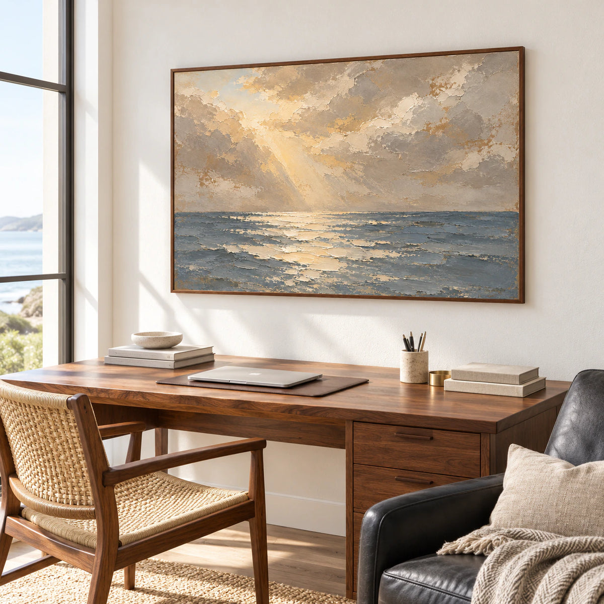 Seascape oil painting above a walnut desk, viewed from the right at a slightly elevated angle, with a black reading chair and daylight from a side window.