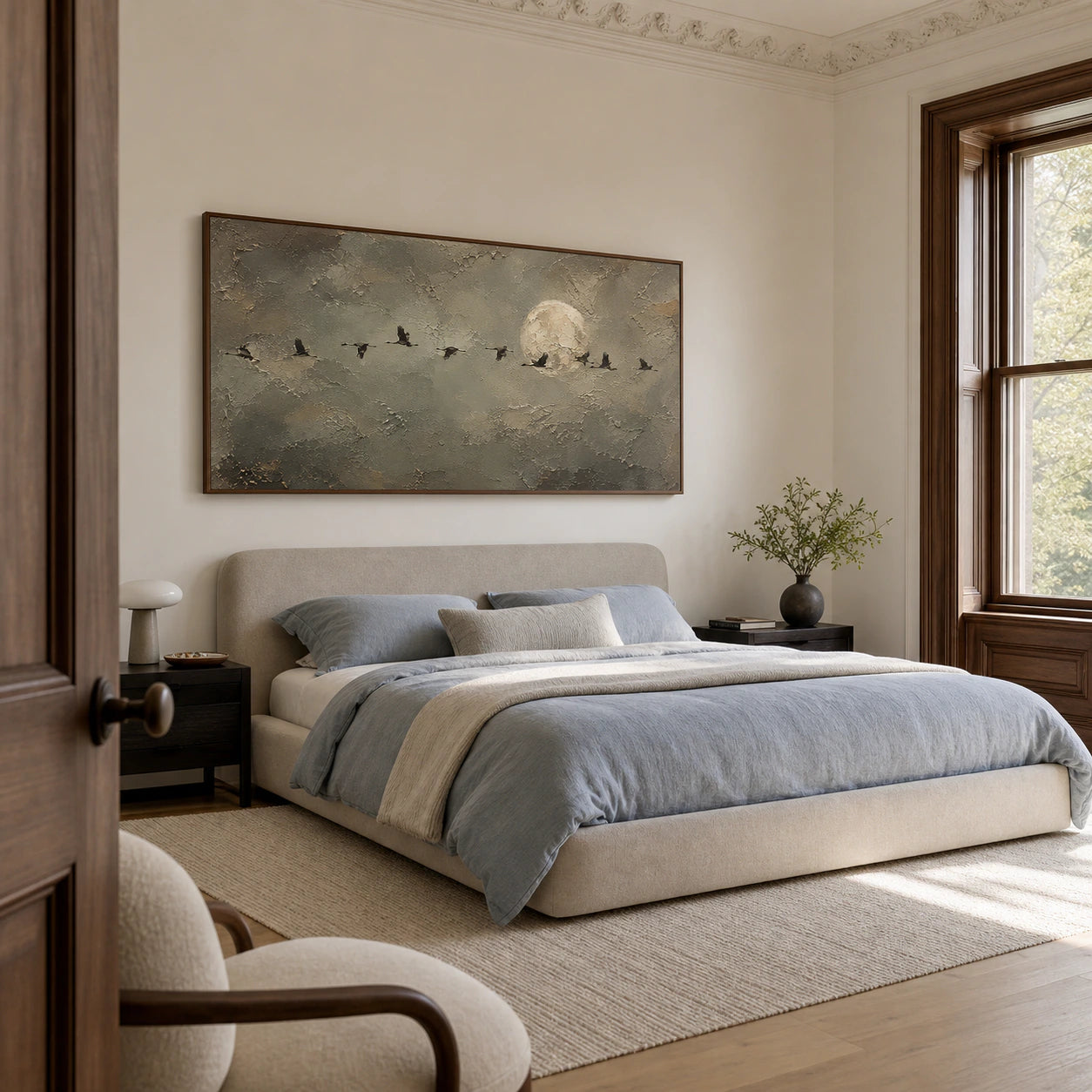 Lunar-Migration above a low blue-grey bed in a quiet bedroom with soft natural light.
