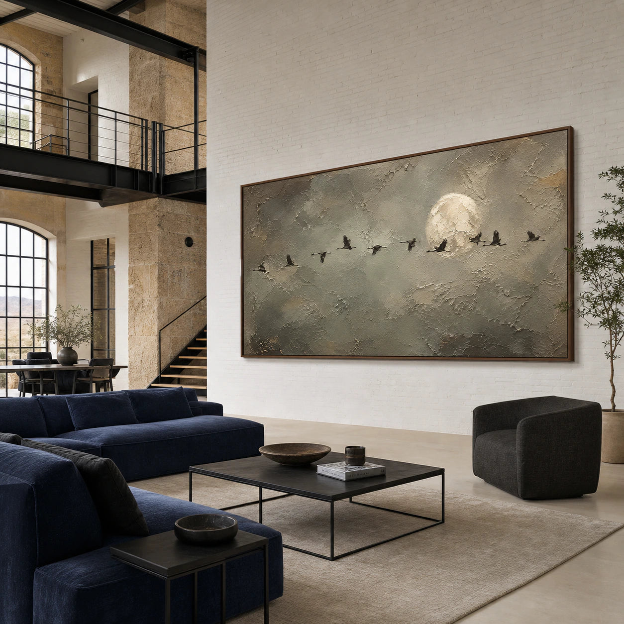 Large Lunar-Migration artwork as the focal point of an expansive, daylight-filled loft lounge.