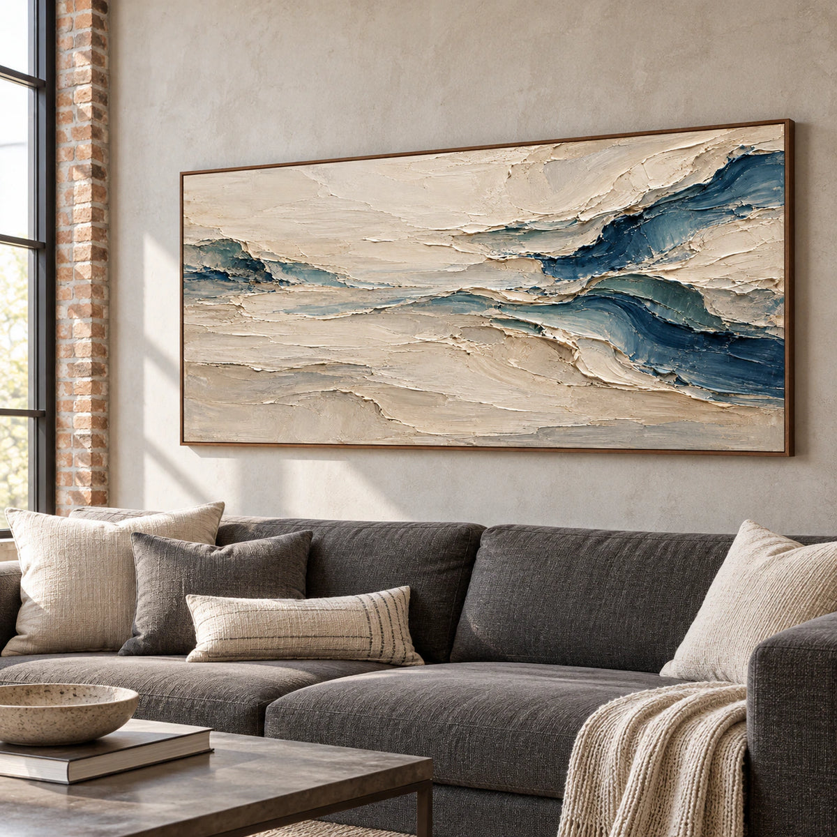 Marine-Fold displayed above a restrained charcoal sofa in a bright, open living room.