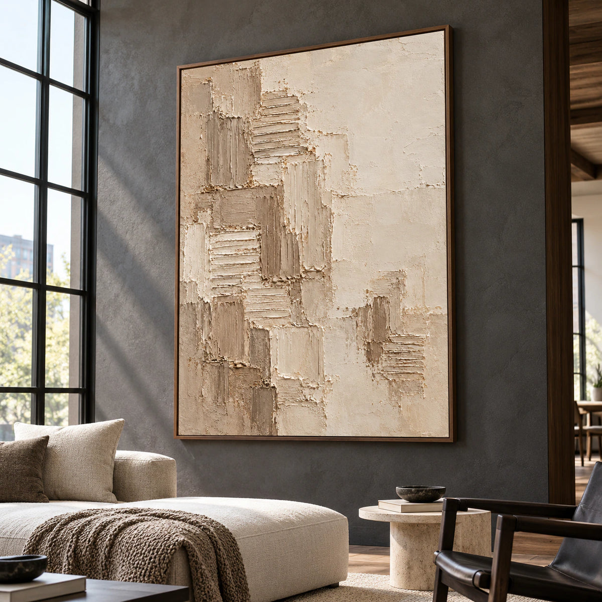 Monumental vertical artwork in an expansive loft interior with tall windows and restrained furnishings.