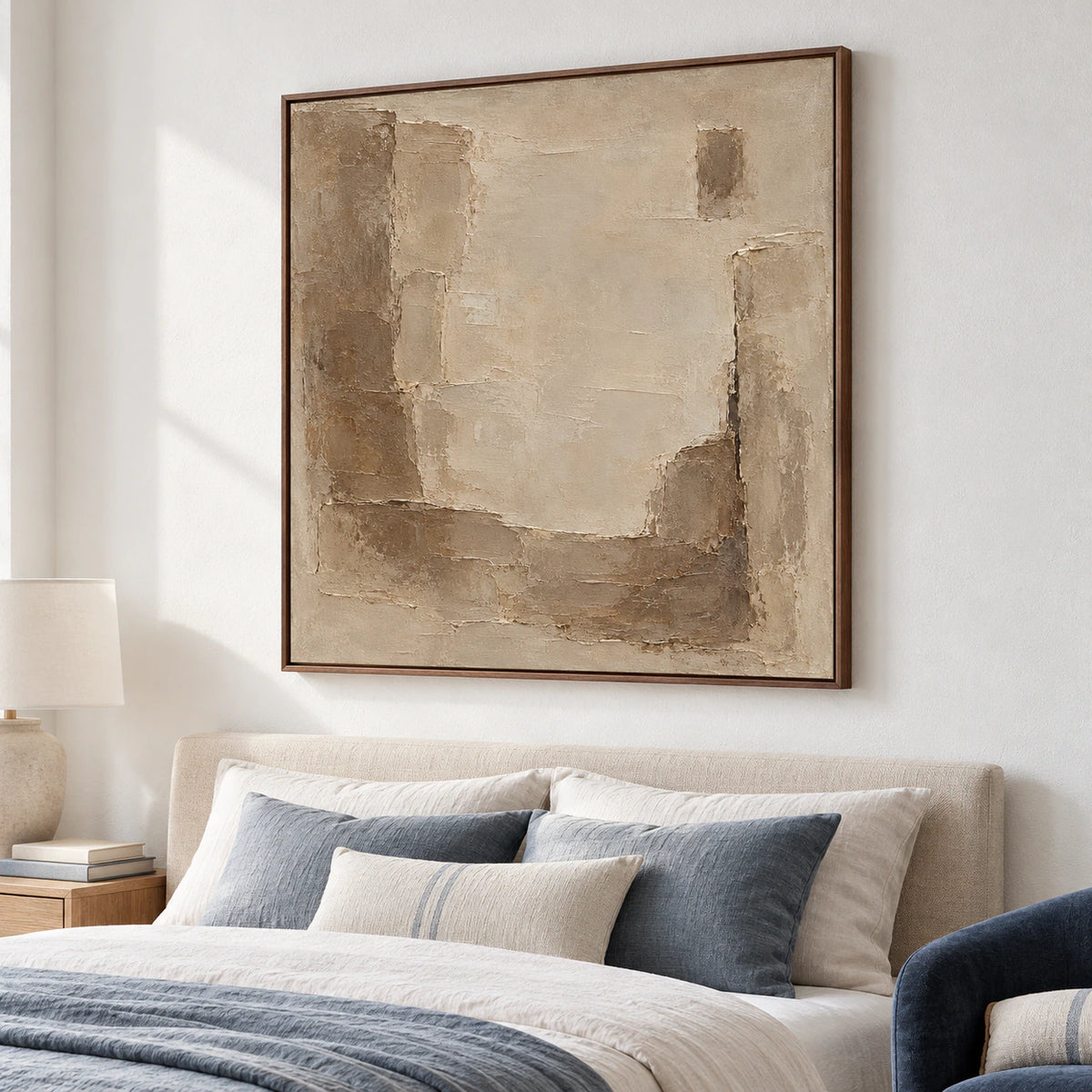 Large square abstract painting above a quiet bedroom headboard in soft daylight.