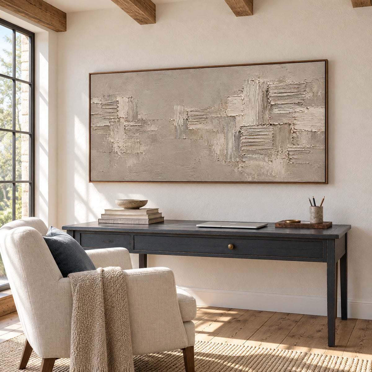 Large textured abstract painting above a desk in an airy home office with daylight.