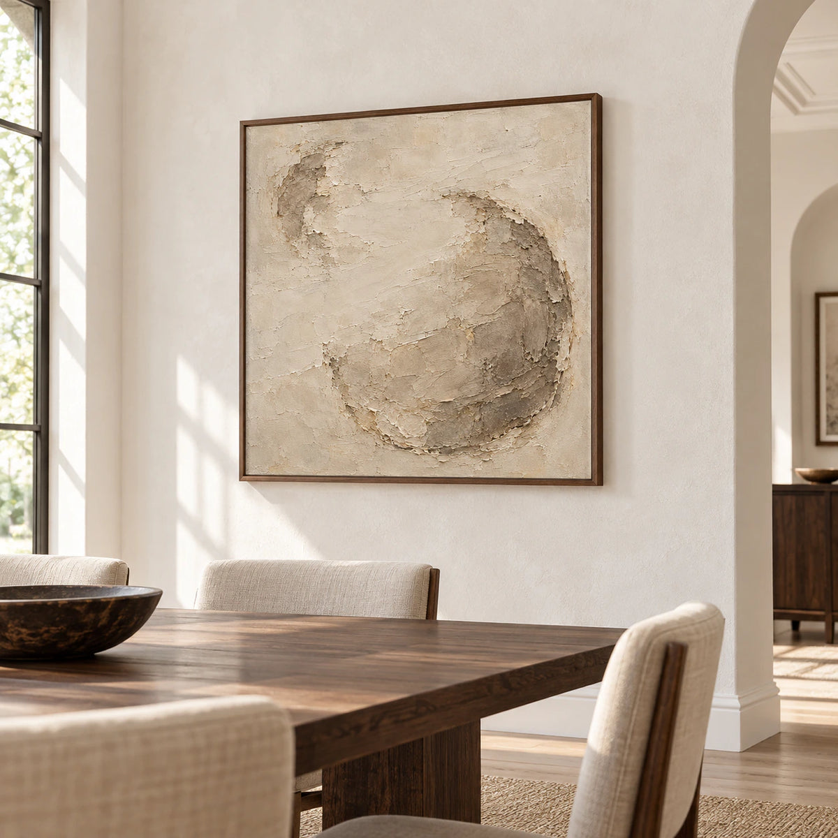 Square ivory and taupe abstract relief above a dark wood dining table in a refined dining room.