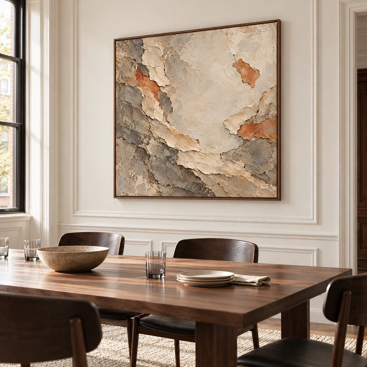 Marl-Unfurl painting on a soft white plaster wall beside a long walnut dining table with dark chairs and sparse glassware, viewed from the right.