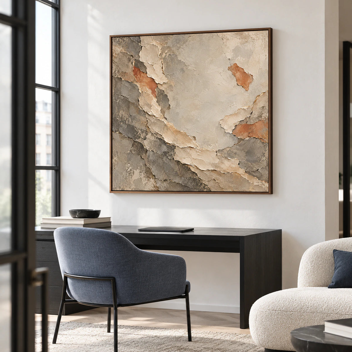 Marl-Unfurl painting on a cool white wall in a sunlit home office with a black desk and blue-gray reading chair, viewed from the left at standing height.