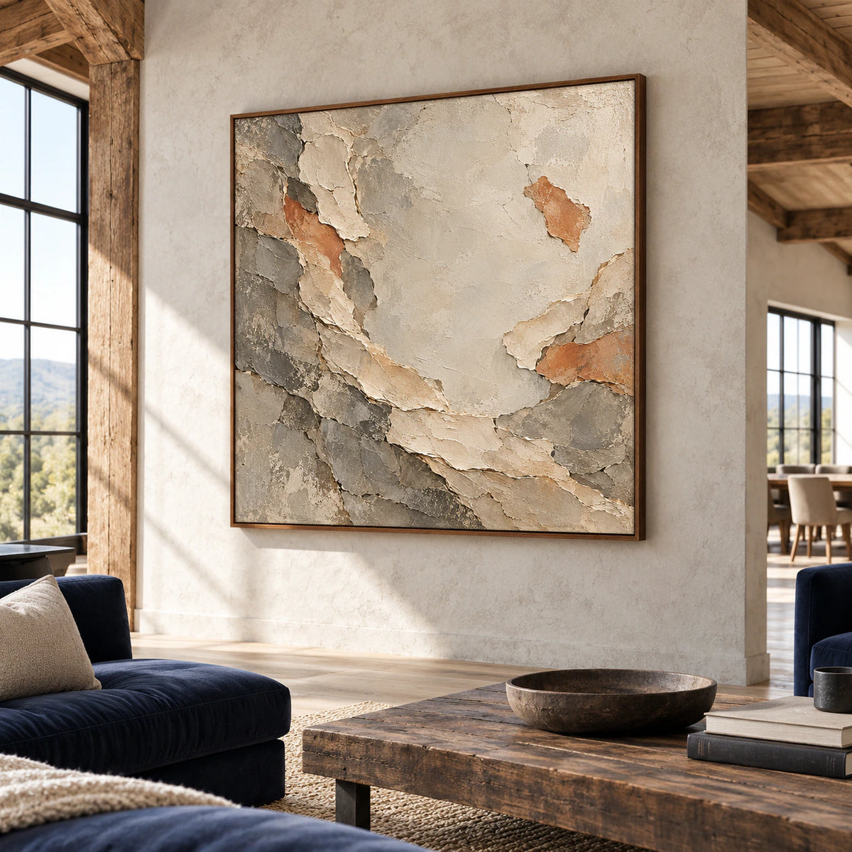 Marl-Unfurl painting on a pale concrete wall in a spacious hospitality loft with navy lounge chairs and dark furniture, viewed from the left across the sunlit seating area.