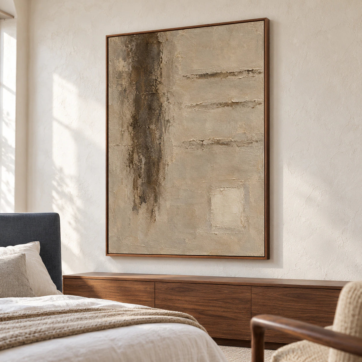 Vertical textured abstract painting above a bed with white linen and a slate-blue headboard, viewed from a low left angle in a bright bedroom.