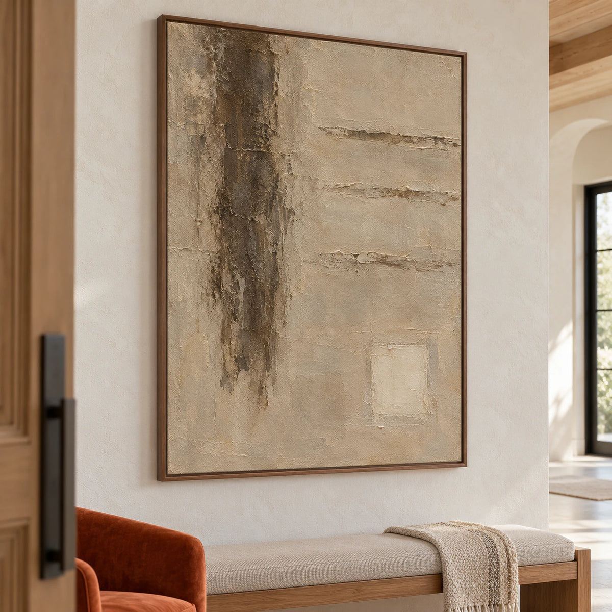 Vertical textured abstract painting viewed from an elevated left angle in a bright foyer with pale stone walls, dark metal details and a single bench.