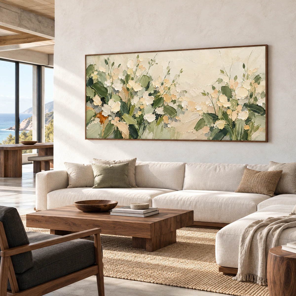 Wide floral painting in a bright loft lounge with pale concrete walls, a deep charcoal bench and walnut furnishings, viewed from the right.