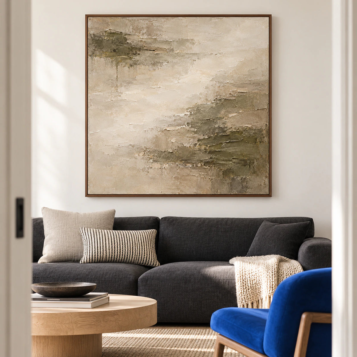 Mineral-Fold displayed above a low charcoal sofa in a bright, open living room.