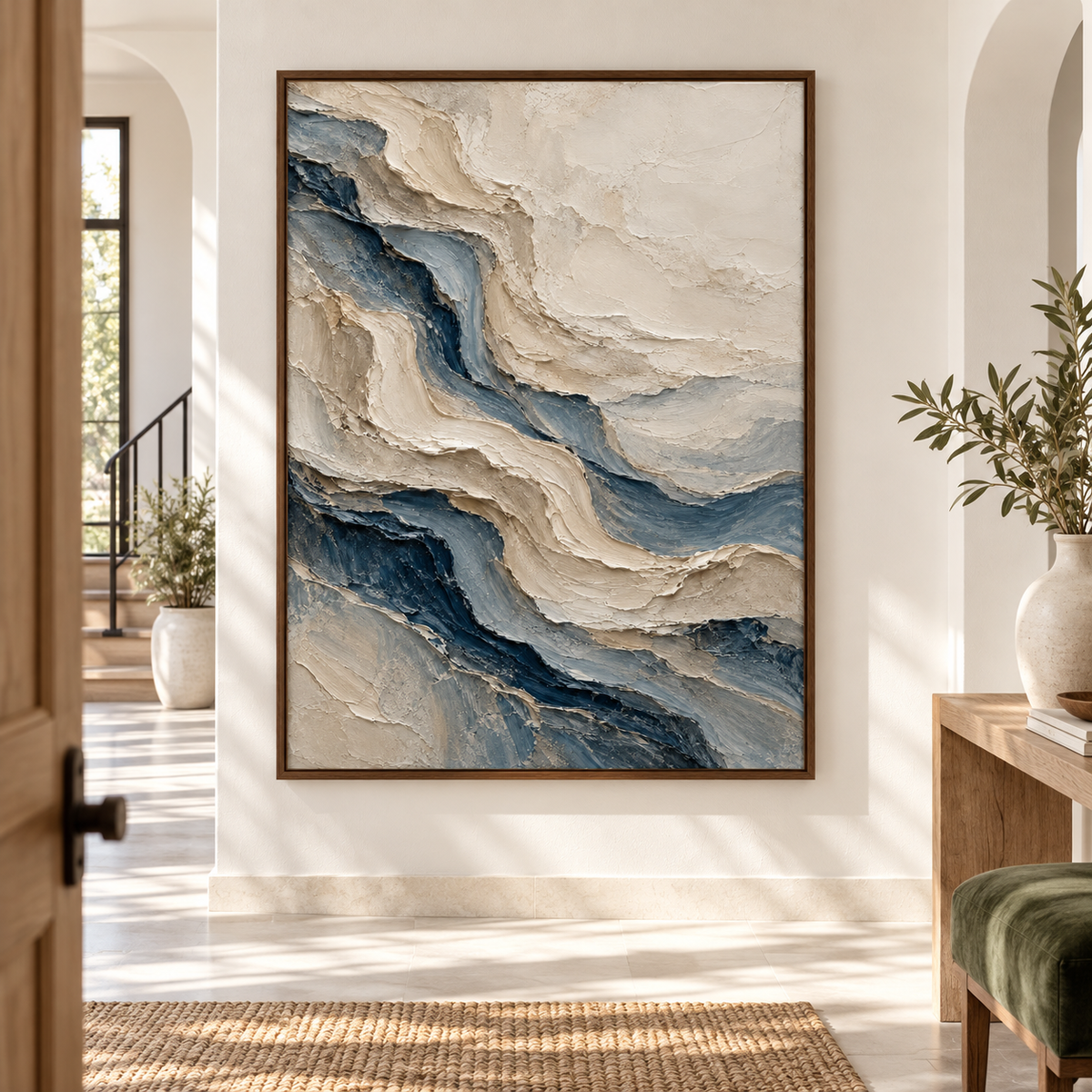 Large vertical textured painting on a warm white wall in a bright, high-ceilinged foyer with pale stone flooring, viewed from a low left-oblique angle.