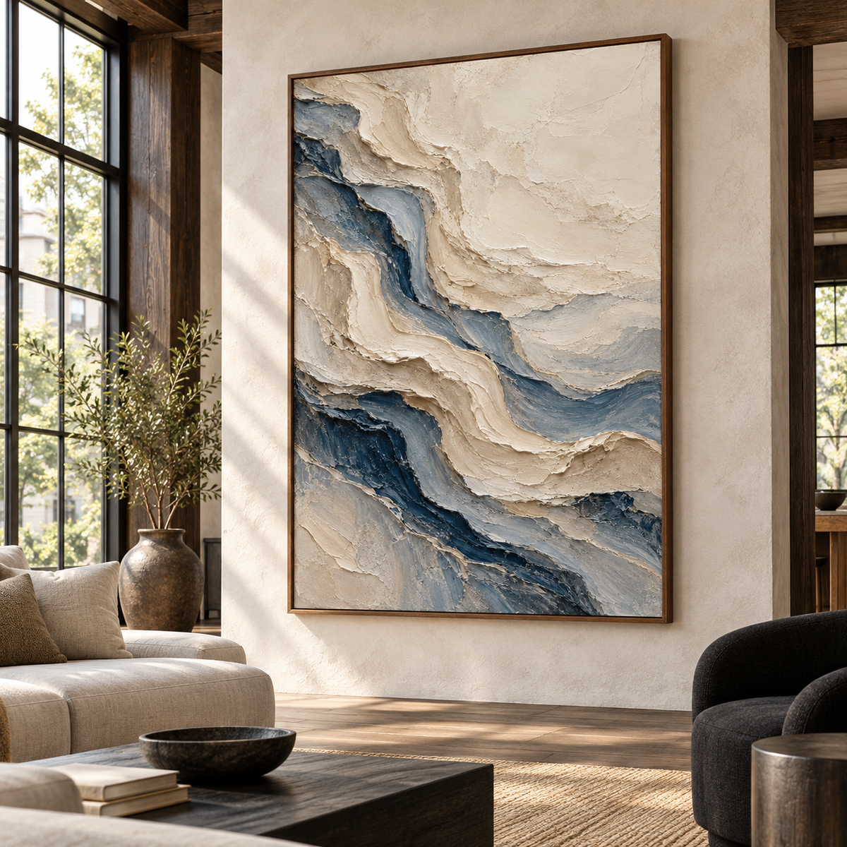 Large vertical ivory and blue-gray painting in an expansive interior with high ceilings, broad windows, a pale wall and black seating, viewed from the distant right.