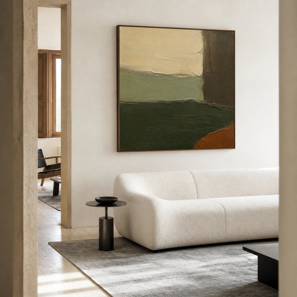 Moss-Ember above a restrained sofa in a bright contemporary living room.