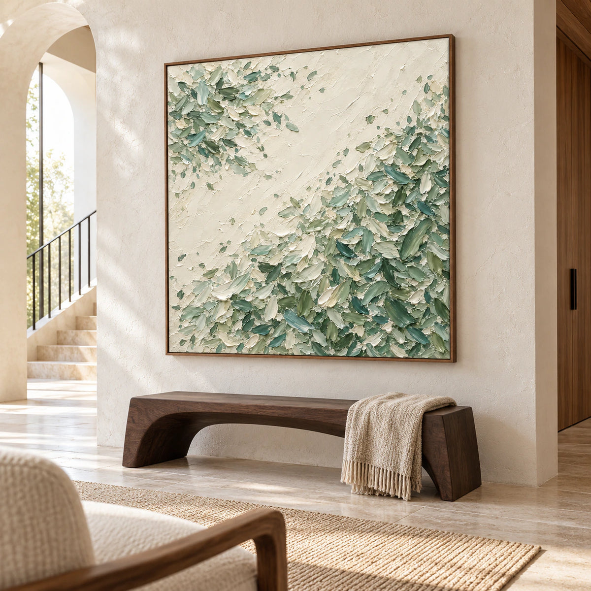 Low left-oblique view of large square Moss-Traverse in a spacious foyer with pale stone walls, a sculptural dark bench and open floor space.