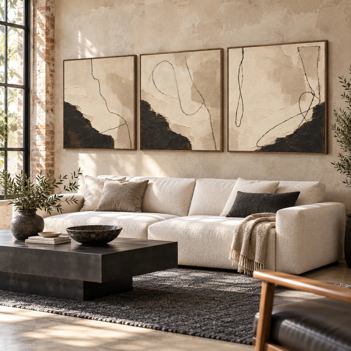 Noir-Calligraphy triptych displayed above a sofa in a bright contemporary living room.