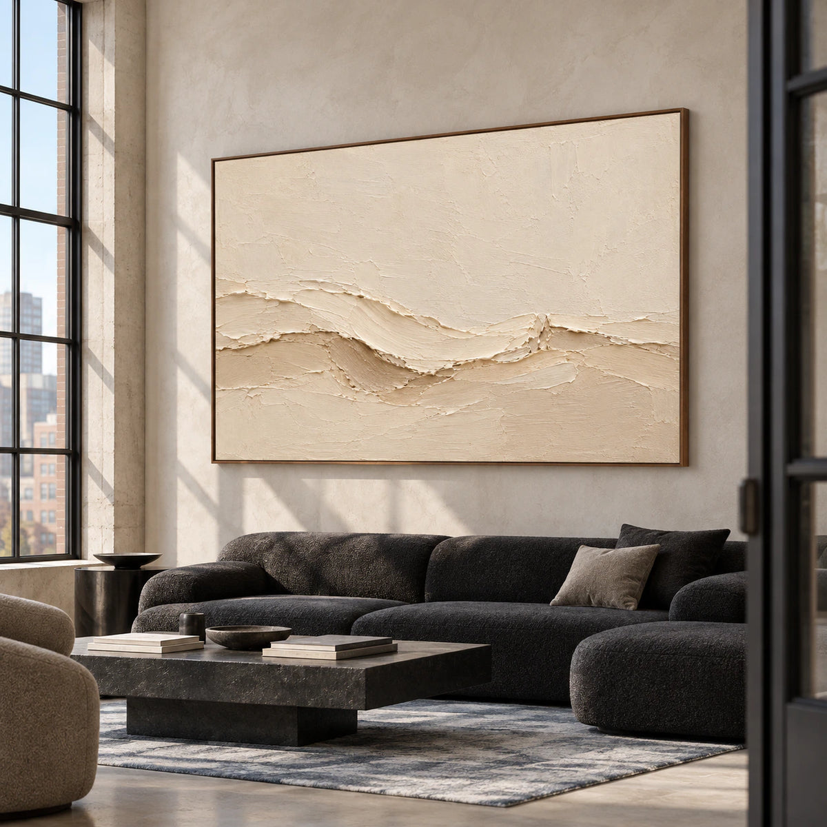 Warm ivory textured painting in an expansive loft lounge with concrete architecture, tall windows and dark furnishings, viewed from the right at standing height.