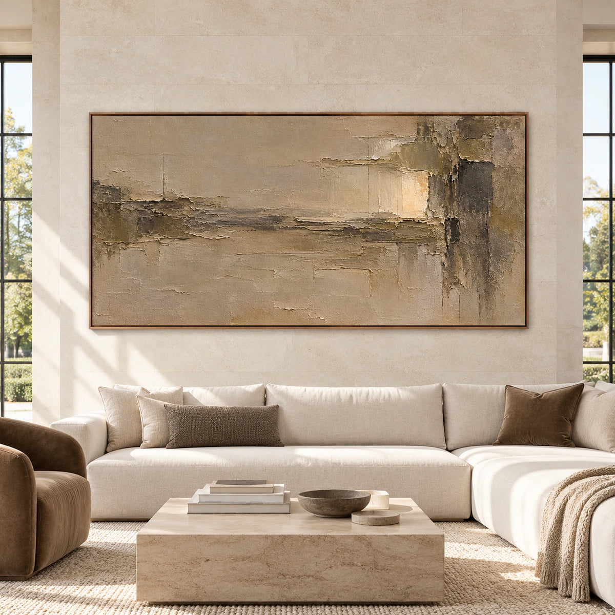 Ochre and umber abstract painting above a cream sofa against a light stone wall in a spacious, bright room, viewed straight on.