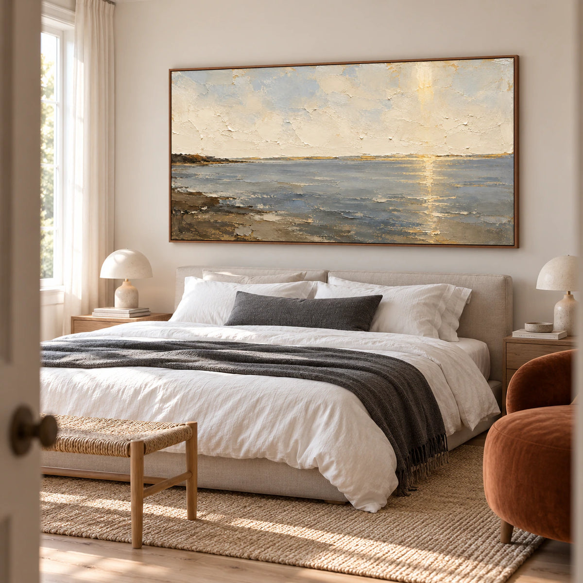 Ochre-Meridian seascape above a low bed with cool white linen and a muted charcoal accent, against light walls and viewed from a slightly elevated angle on the left.