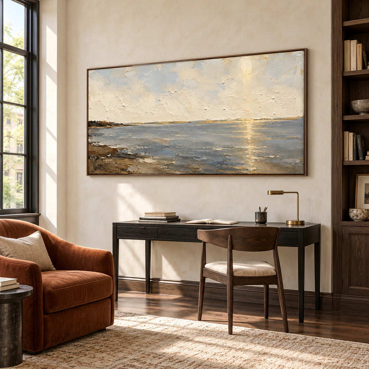 Ochre-Meridian seascape on a pale home office wall with a compact black desk, rust-colored reading chair and tall window, viewed from low on the right.