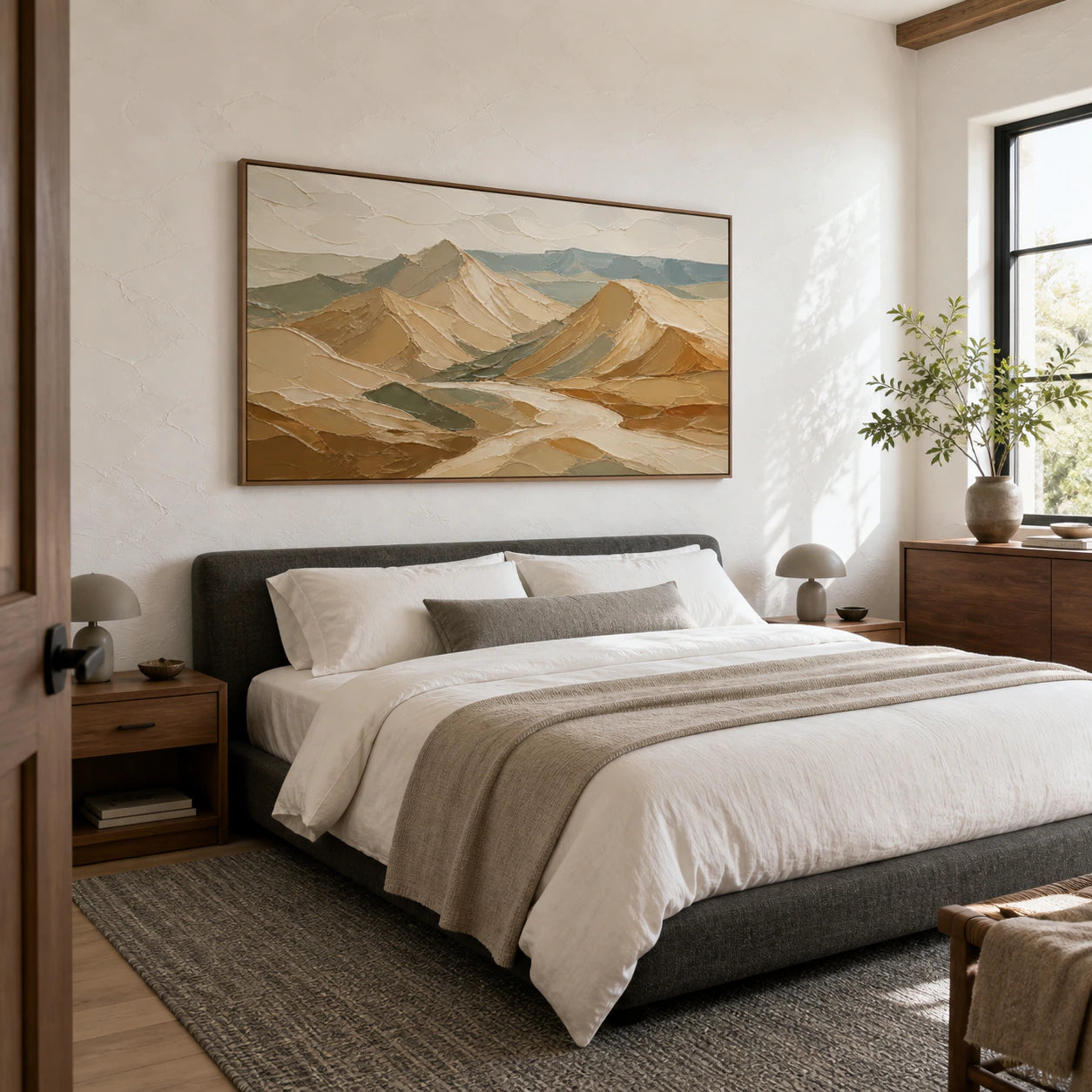 Ochre mountain landscape painting in a quiet, light-filled bedroom.